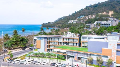 an aerial view of a building next to the ocean at The Nature Phuket - SHA Extra Plus in Patong Beach
