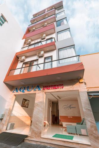 a tall building with an akoya hotel at AQUA Seaview Hotel in Nha Trang
