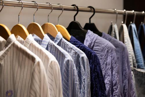 a row of shirts hanging on a rack at Kyoto U-BELL Hotel in Kyoto