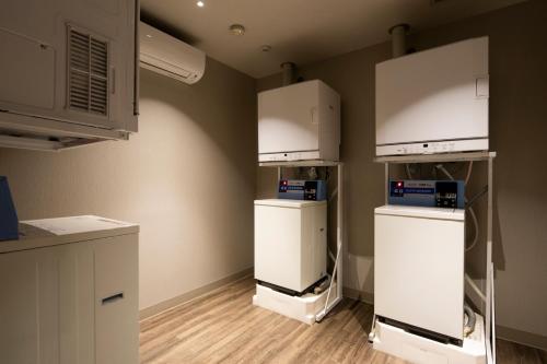 a room with refrigerators and cabinets in a room at Kyoto U-BELL Hotel in Kyoto