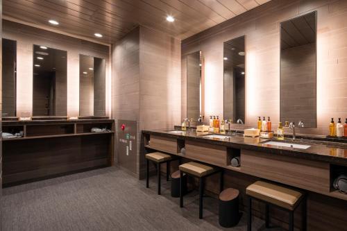 a bathroom with two sinks and two mirrors at Kyoto U-BELL Hotel in Kyoto