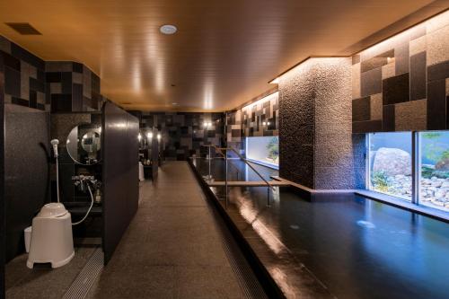 a bathroom with a urinal and a toilet in it at Kyoto U-BELL Hotel in Kyoto