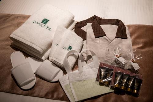 a pile of towels and other products on a table at Kyoto U-BELL Hotel in Kyoto