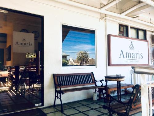 a store front with a bench and a table at Amaris Bed & Breakfast in Mactan