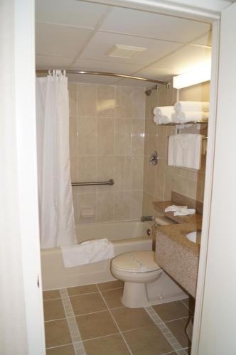 a bathroom with a toilet and a tub and a sink at Beau Rivage Beach Resort in Wildwood Crest