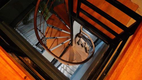 an overhead view of a spiral staircase with a clock at Michel'inn Coron in Coron