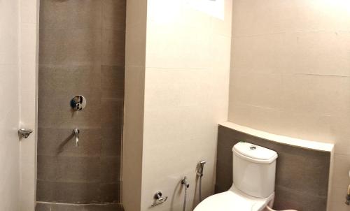 a bathroom with a toilet and a shower at Pride Home in Chandīgarh