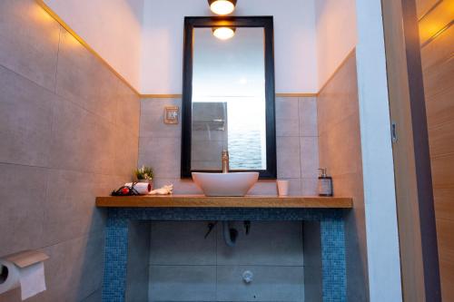 a bathroom with a sink and a mirror at Trip Villa in Ukulhas