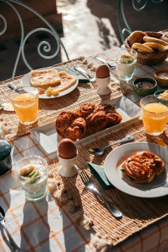 a table with breakfast foods and drinks on it at Riad Albatoul in Marrakech