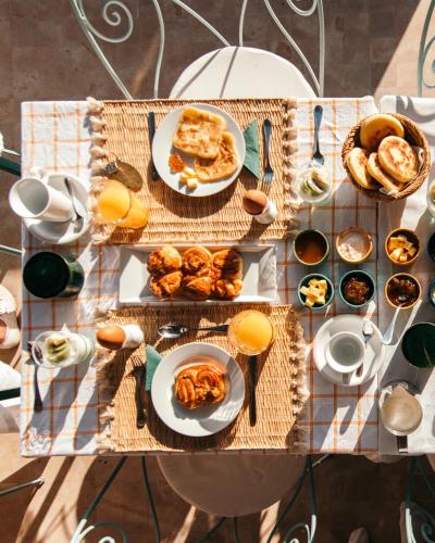a table with plates of food on top at Riad Albatoul in Marrakech