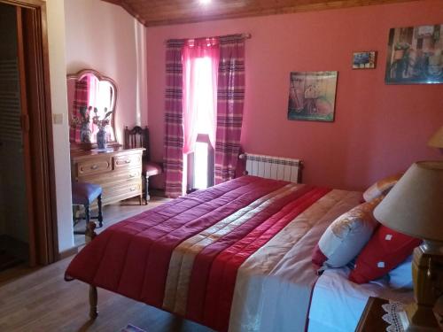 a bedroom with a bed and a dresser and a window at Hotel gite cantinho davo in Vila Real