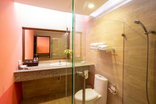 a bathroom with a toilet, sink, and shower at Beyond Resort Krabi in Klong Muang Beach