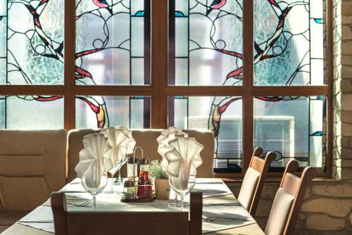a dining room with a table and a stained glass window at SPA complex Elena in Elena