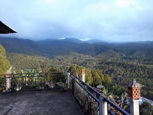a view of the mountains from the balcony of a house at One Homestay and Warung in Munduk