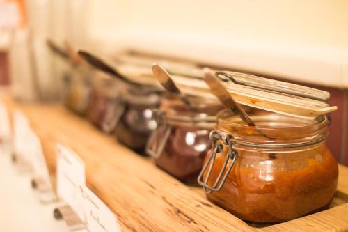 a row of jars of jam on a counter at Gastwirtschaft & Hotel Holzinger in Möllersdorf