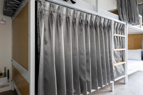 a bunk bed with grey curtains in a bedroom at 109台北旅館-台北109青旅 109 Taipei Hotel - Taipei 109 Hostel in Taipei