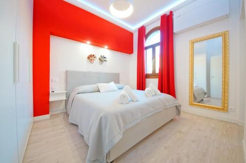 a red bedroom with a bed and a mirror at DolceVita Apartments N 439 in Venice