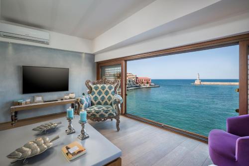 a living room with a view of the ocean at Residenza Vranas Boutique Hotel in Chania Town