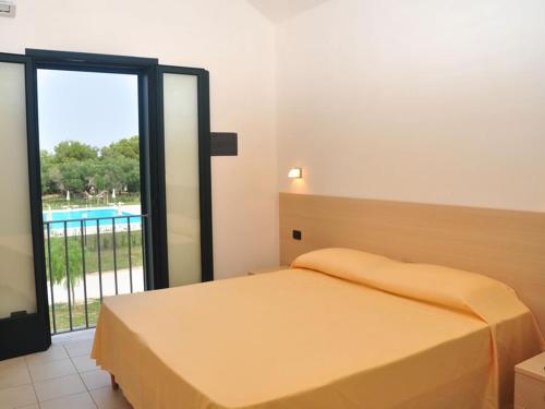 Blu Mare Frassanito - Residence tesisinde bir odada yatak veya yataklar