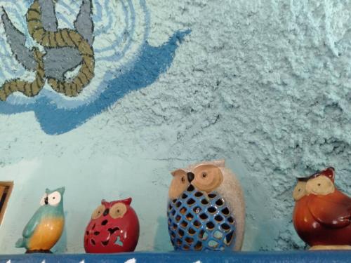 a group of figurines of owls sitting on a shelf at Kenting Ha-Bi Star Fort in Hengchun
