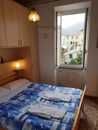 a bedroom with a bed and a window at House Camogli in Camogli