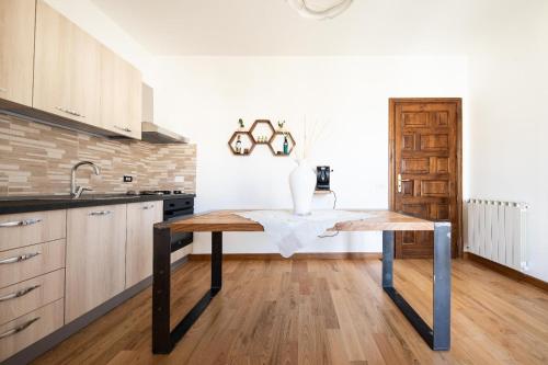 a kitchen with a table with a vase on it at B&B Antares in Cittanova