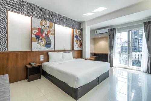 Ένα ή περισσότερα κρεβάτια σε δωμάτιο στο Cozytel Chiangmai
