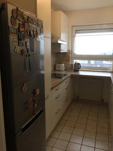 a kitchen with a refrigerator with magnets on it at Sonnenschein in Idstein