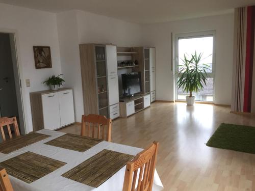 a large living room with a table and a television at Sonnenschein in Idstein