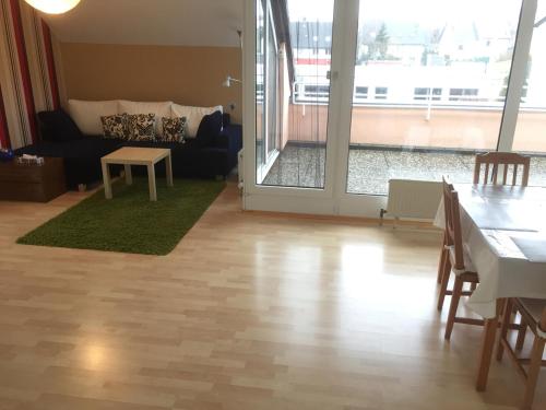 a living room with a table and a couch at Sonnenschein in Idstein