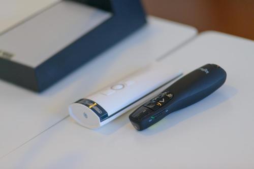 a remote control sitting on a table next to a box at Hotel Cristallo in Riccione