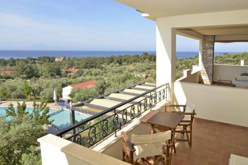 a balcony of a villa with a view of the ocean at Moonbeam Hotel in Pefkari