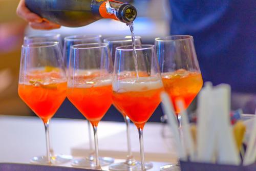 a group of wine glasses filled with orange juice at Hotel Cristallo in Riccione