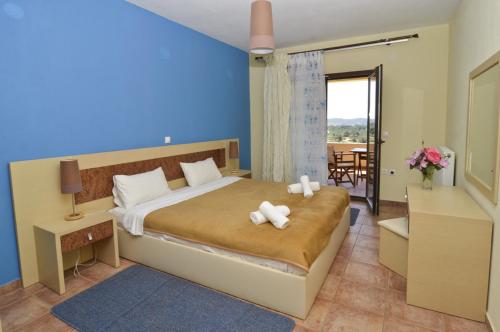 Ένα ή περισσότερα κρεβάτια σε δωμάτιο στο Ξενοδοχείο 'Στη γειτονιά του Φεγγαριού'