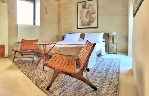 a bedroom with a bed and a table and chairs at La Fiermontina Luxury Home Hotel in Lecce
