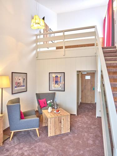 a living room with a loft bed at Parkhotel Bad Griesbach in Bad Griesbach