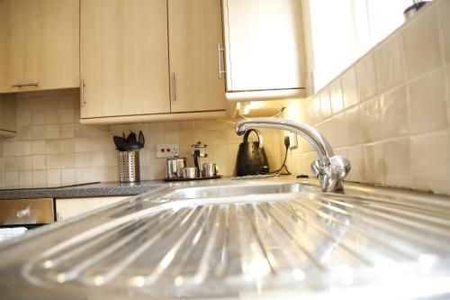 a kitchen sink with a faucet in a kitchen at Sea Thrift in Newquay