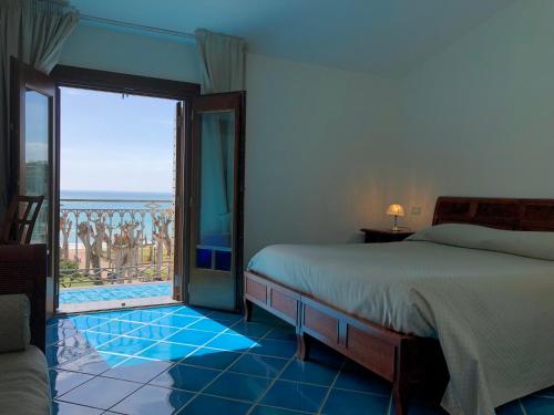 a bedroom with a bed and a view of the ocean at Hotel Pisacane in Sapri