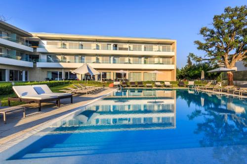 una piscina con sedie e un edificio di Monte Real - Hotel, Termas & Spa a Monte Real