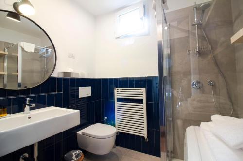a bathroom with a toilet and a sink and a shower at Sant'Andrea cozy apartment in Milan