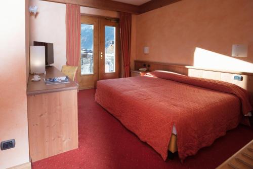 a hotel room with a bed and a television at Miramonti Park Hotel in Bormio