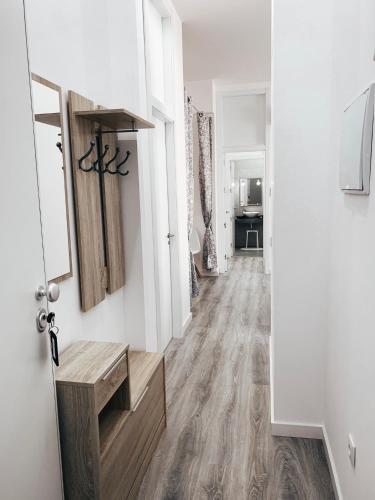 a hallway with white walls and a wooden floor at Alicante Center Apart in Alicante
