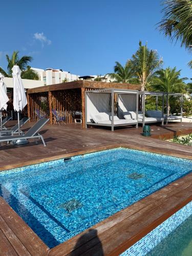 a swimming pool on a wooden deck next to a resort at La Amada condo with Marina View in Cancún