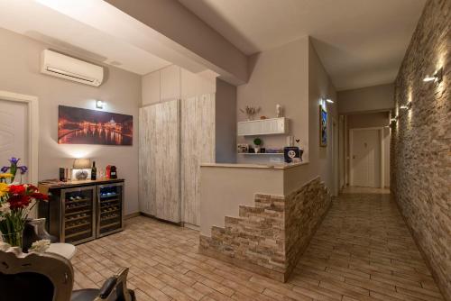 a living room with a counter and a kitchen at Five Rooms Rome Guesthouse in Rome