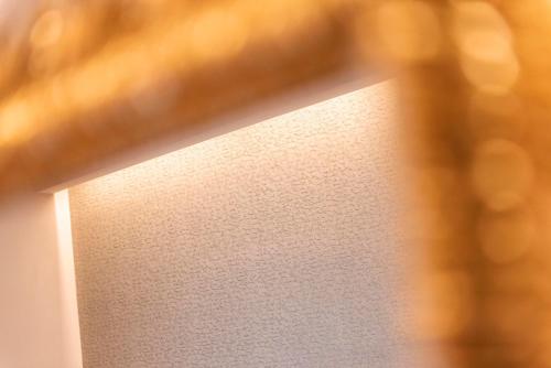 a close up of a wall with a light on it at Five Rooms Rome Guesthouse in Rome