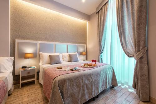 a hotel room with a bed and a window at Five Rooms Rome Guesthouse in Rome