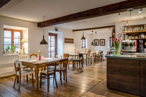 a dining room with tables and chairs and a bar at Gasthaus Unterwirt in Fridolfing