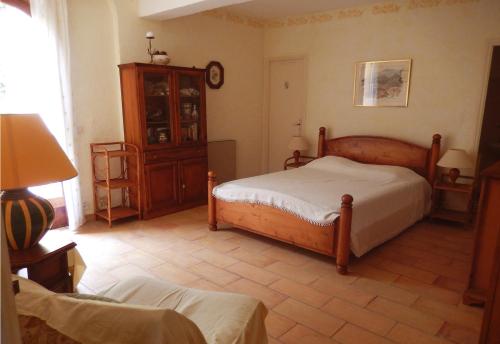 a bedroom with two beds and a clock on the wall at Grande Villa, Corse du Sud, Domaine privé de Cala Rossa in Porto-Vecchio