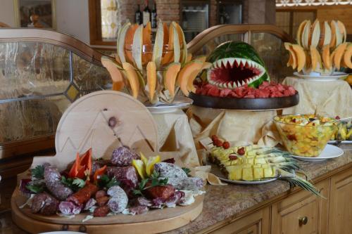 a buffet of different types of food on a counter at Rio Stava Family Resort & Spa in Tesero