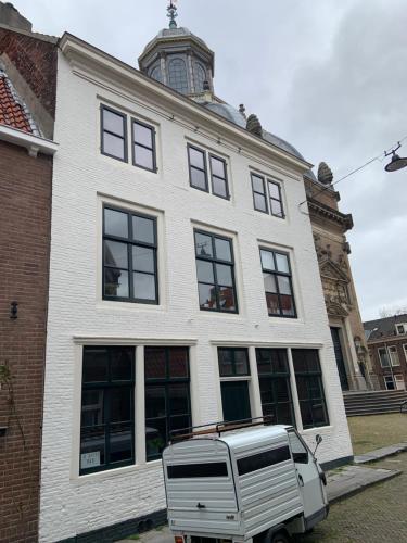 a white truck parked in front of a building at Appartement OKP15 in Middelburg